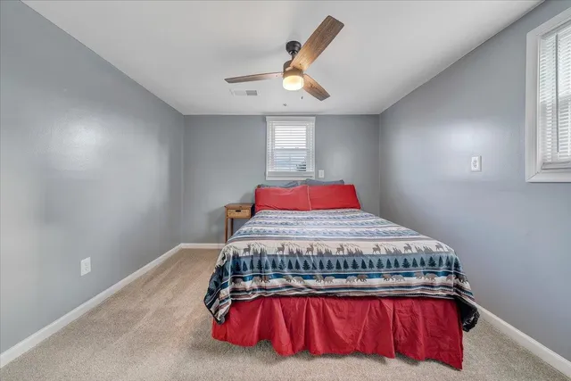 a bedroom with a bed with wooden floor