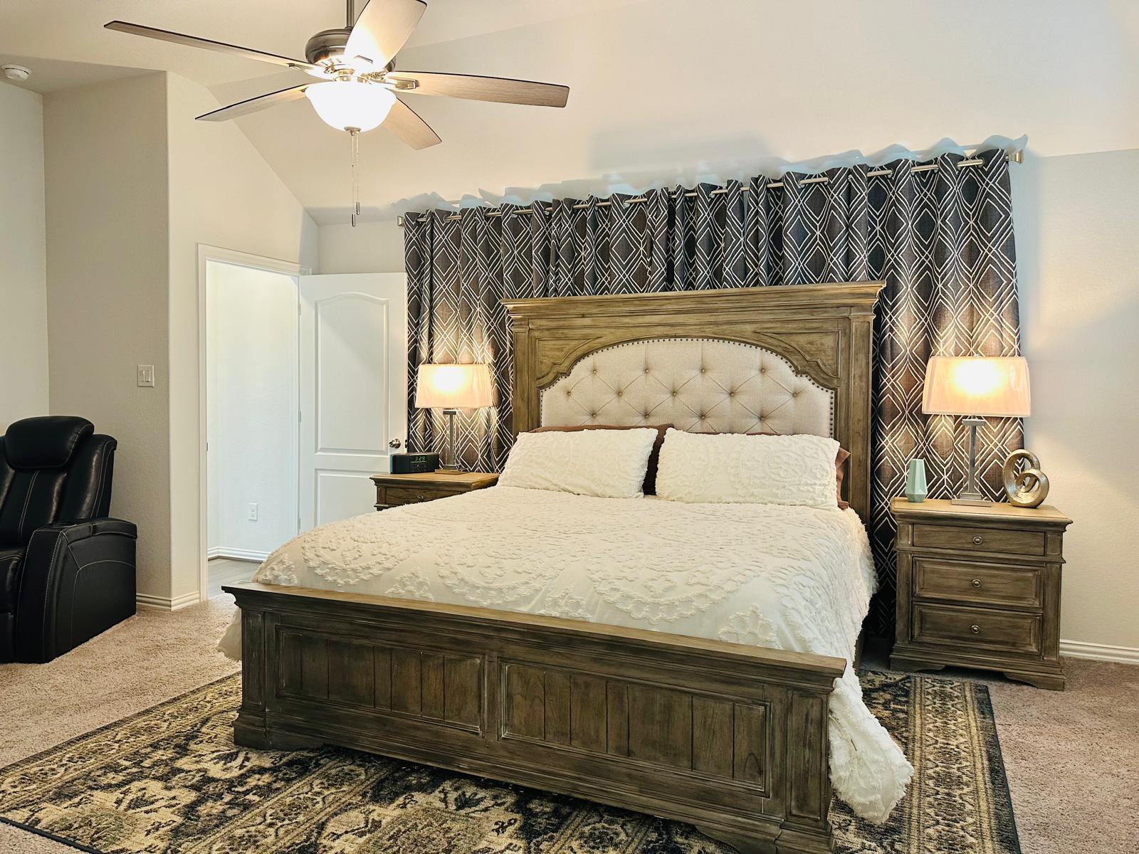 862 Leadtree Loop Buda, TX 78610 - Photo 21 of 40 a bedroom with a bed and wooden floor
