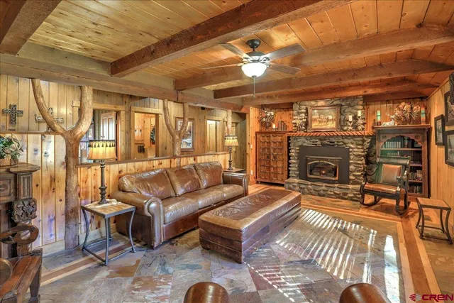 a living room with furniture a flat screen tv and a fireplace