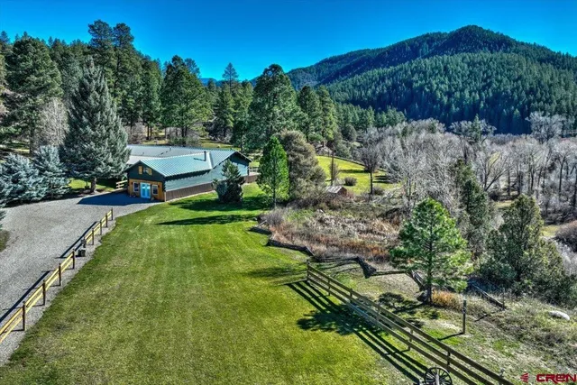a view of a backyard with swimming pool