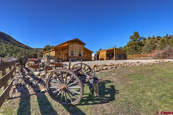 a view of a dining room with furniture a chandelier and wooden floor