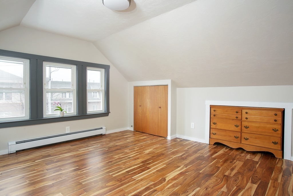 517 Heath Street Brookline, MA 02467 - Photo 11 of 12 an empty room with wooden floor and windows