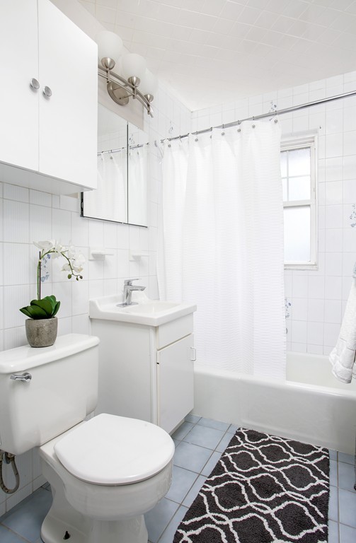 517 Heath Street Brookline, MA 02467 - Photo 8 of 12 a bathroom with a sink toilet and shower