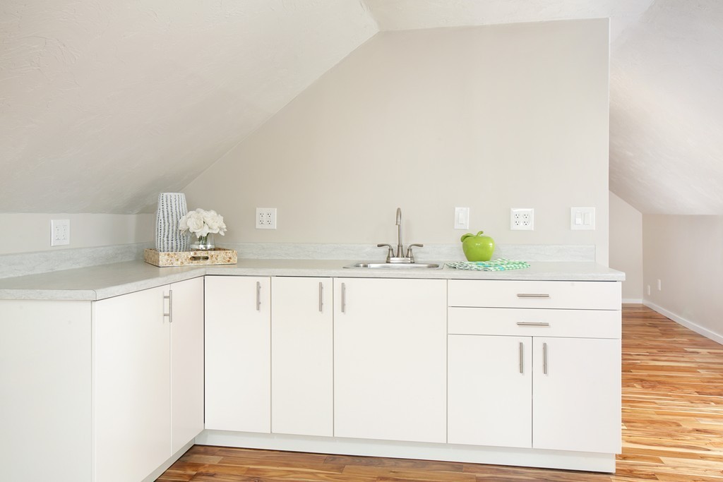 517 Heath Street Brookline, MA 02467 - Photo 9 of 12 a bathroom with a sink and a mirror