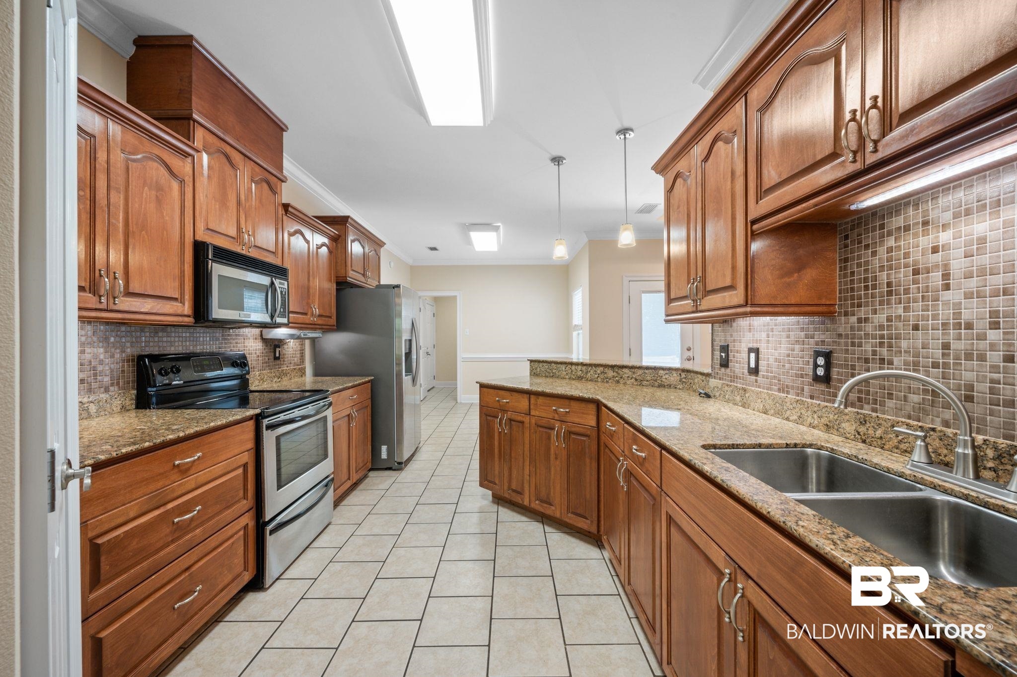 2041 Ridgeline Drive Mobile, AL 36695 - Photo 6 of 43 Kitchen featuring appliances with stainless steel finishes, tasteful backsplash, sink, pendant lighting, and light tile patterned flooring