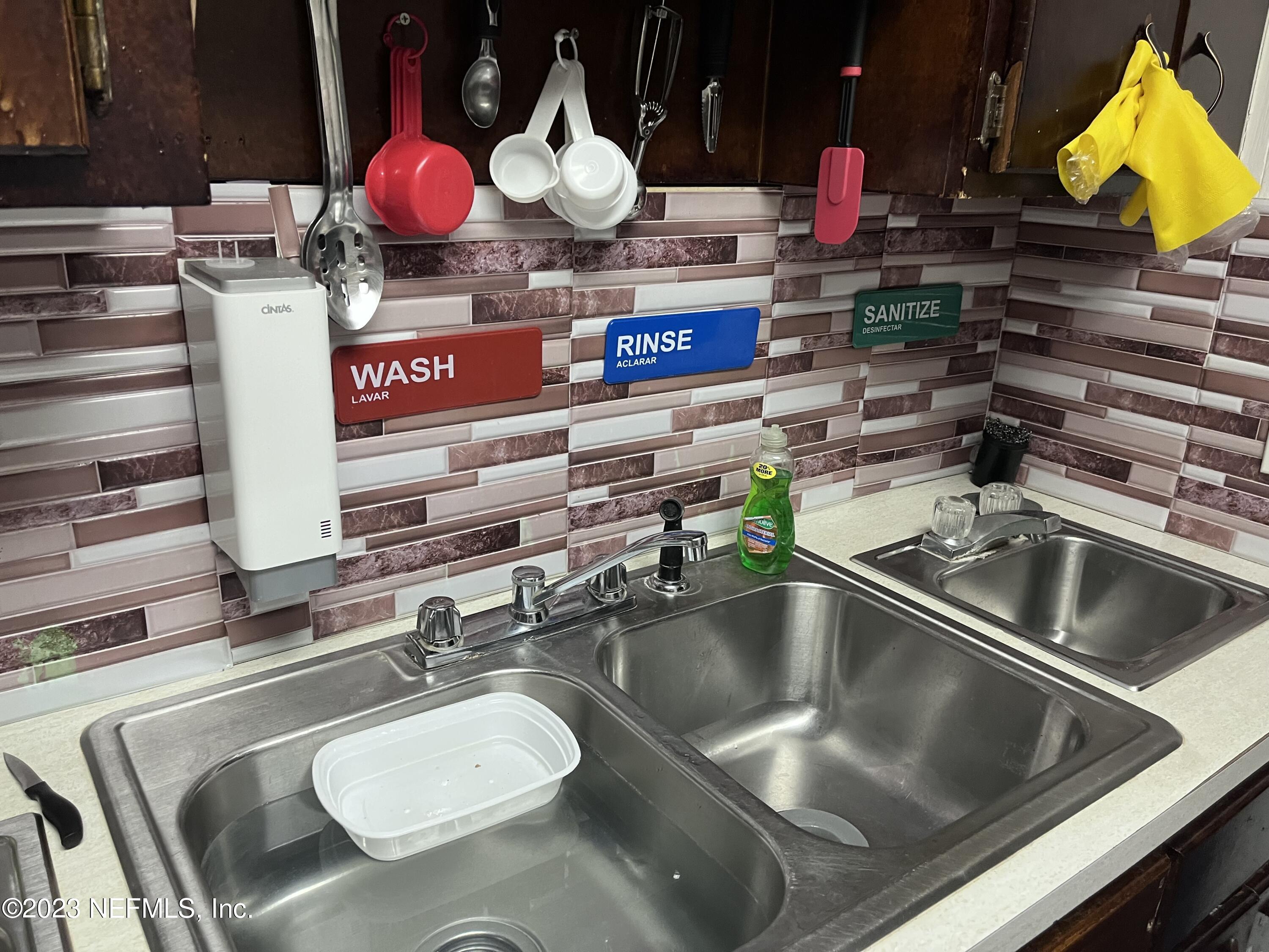 10367 Monaco Drive Jacksonville, FL 32218 - Photo 41 of 49 a kitchen with a sink a stove and cabinets