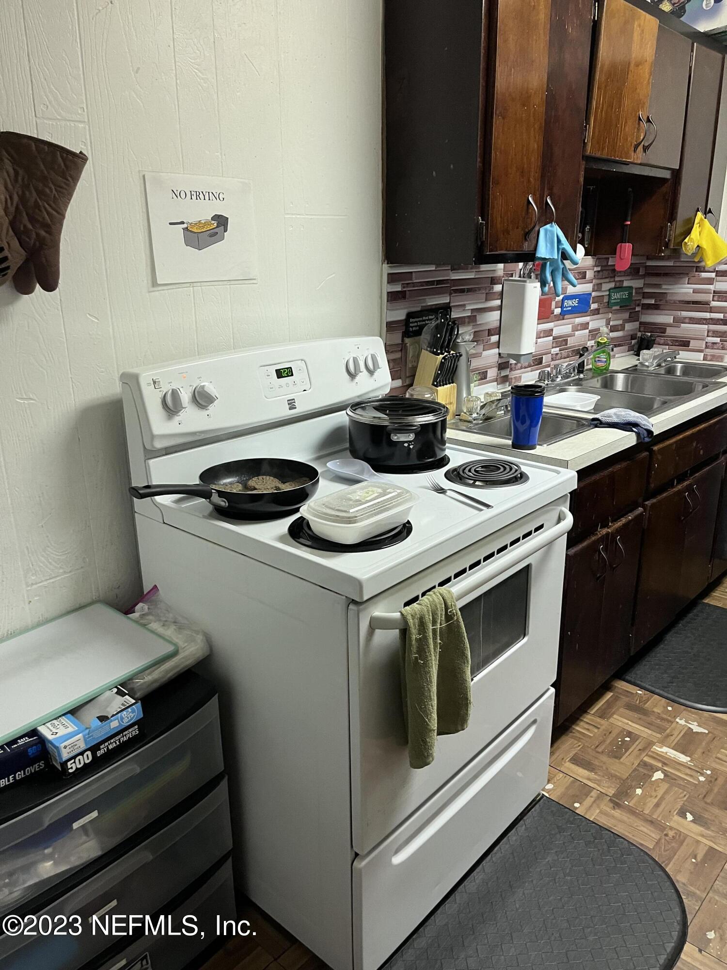 10367 Monaco Drive Jacksonville, FL 32218 - Photo 42 of 49 a white stove top oven sitting inside of a kitchen
