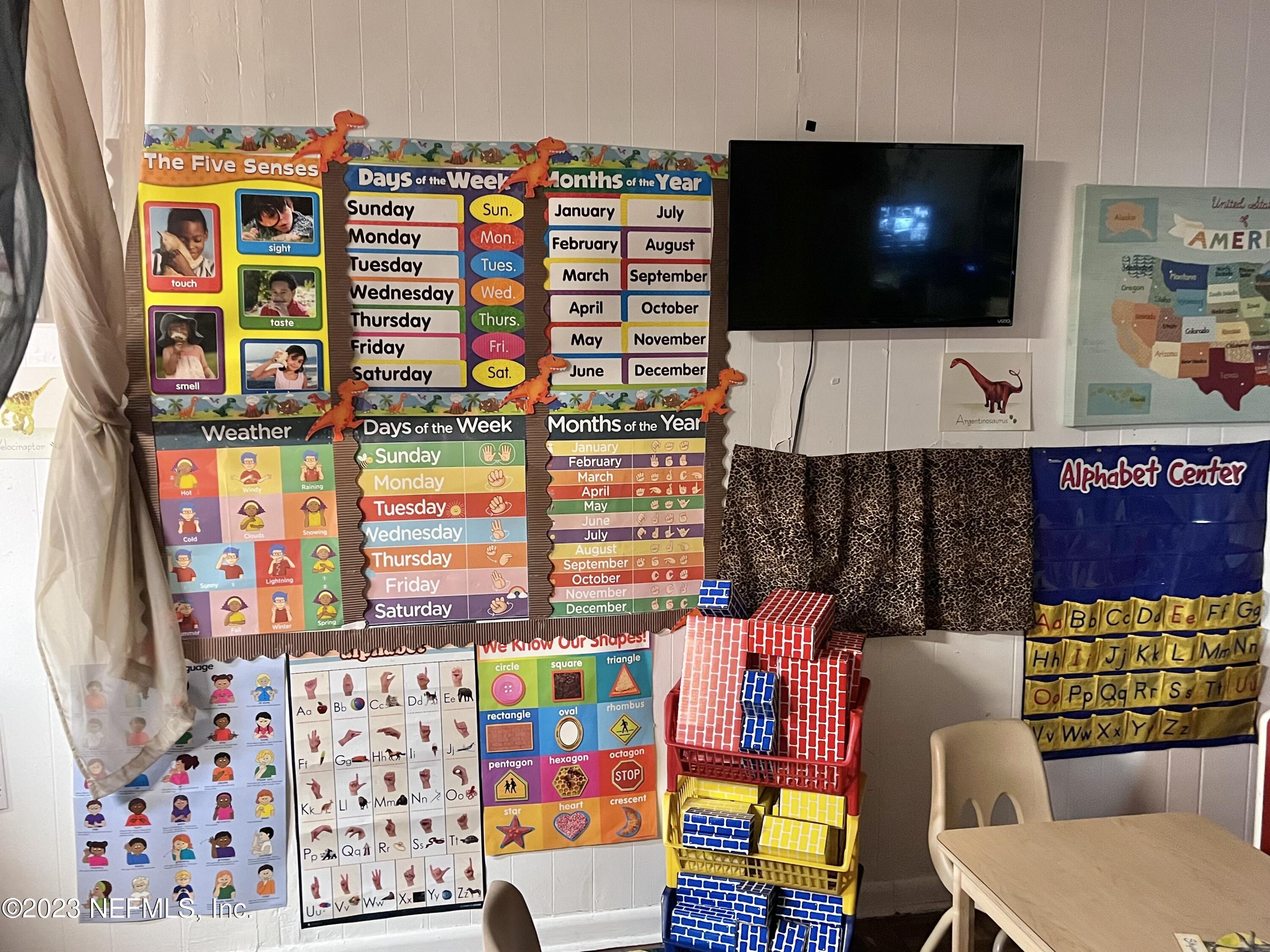 10367 Monaco Drive Jacksonville, FL 32218 - Photo 7 of 49 a living room filled with furniture and a flat screen tv