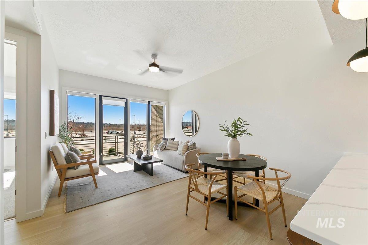 4430 East Haystack Street, Unit 109 Boise, ID 83716 - Photo 5 of 43 Dining room with light wood-style floors, a textured ceiling, and ceiling fan