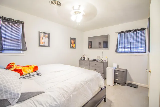 a bedroom with a bed and a tv