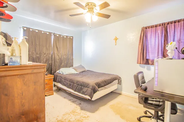 a bedroom with a bed and a table