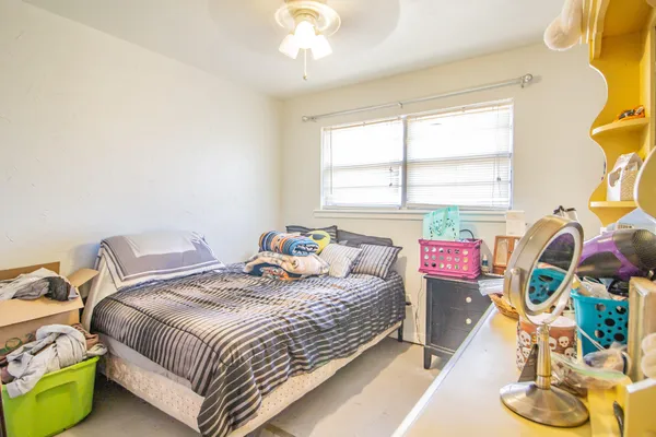 a bedroom with a bed and a window