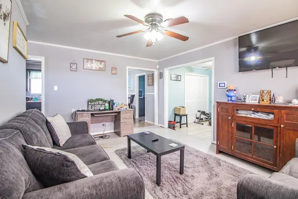 a living room with furniture and a chandelier