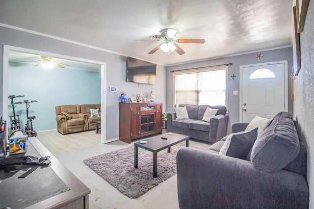 a living room with furniture and a chandelier