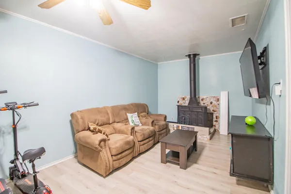 a living room with furniture and a wooden floor
