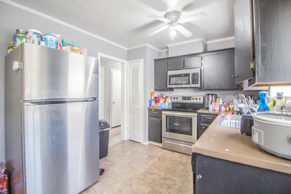 a kitchen with stainless steel appliances granite countertop a refrigerator sink and stove