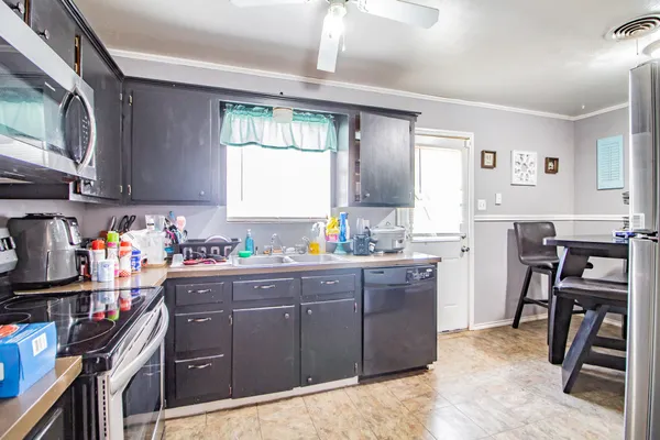 a kitchen with sink cabinets and appliances