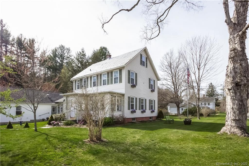 5 West River Road Barkhamsted, CT 06063 - Photo 1 of 1 a front view of a house with a garden and trees