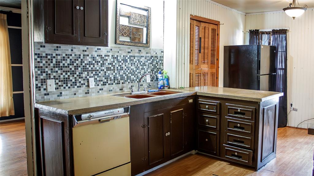 902 West Main Street Olney, TX 76374 - Photo 11 of 24 a kitchen with stainless steel appliances granite countertop a stove and a refrigerator