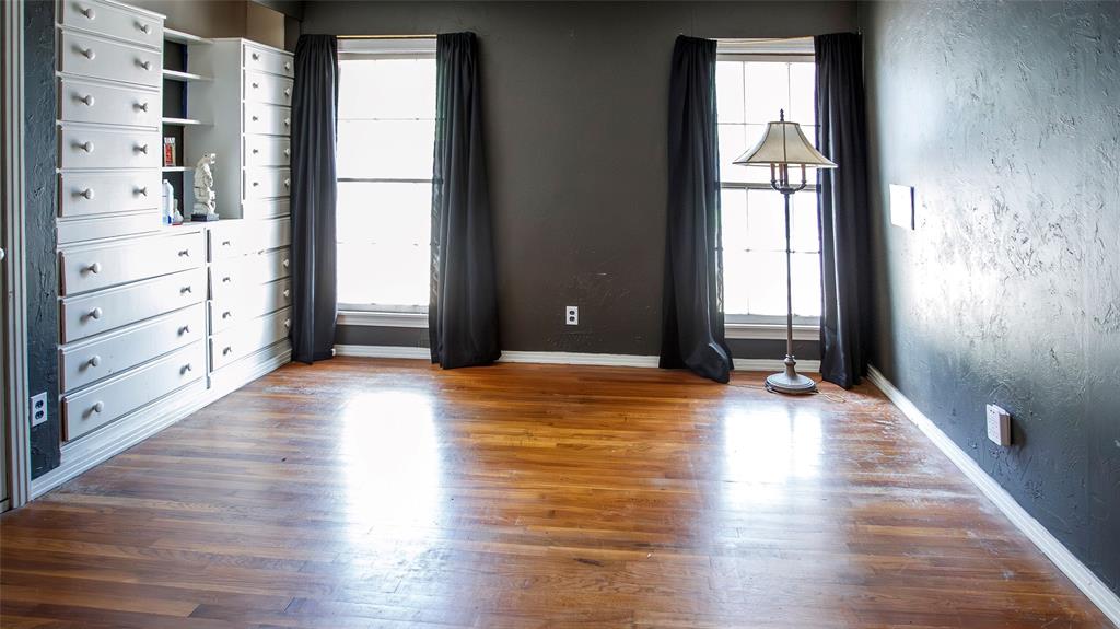 902 West Main Street Olney, TX 76374 - Photo 12 of 24 wooden floor in an empty room with a window