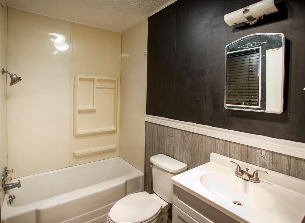 902 West Main Street Olney, TX 76374 - Photo 17 of 24 a bathroom with a sink toilet and shower