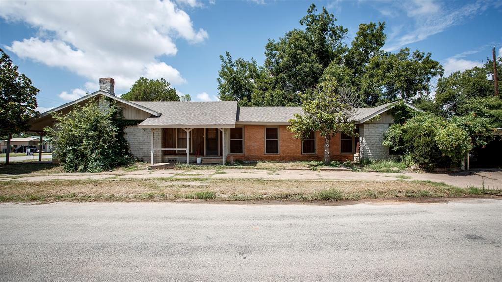 902 West Main Street Olney, TX 76374 - Photo 21 of 24 a front view of a house with a yard and garage