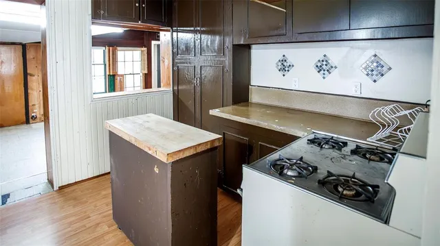 a kitchen with stainless steel appliances granite countertop a stove and a refrigerator