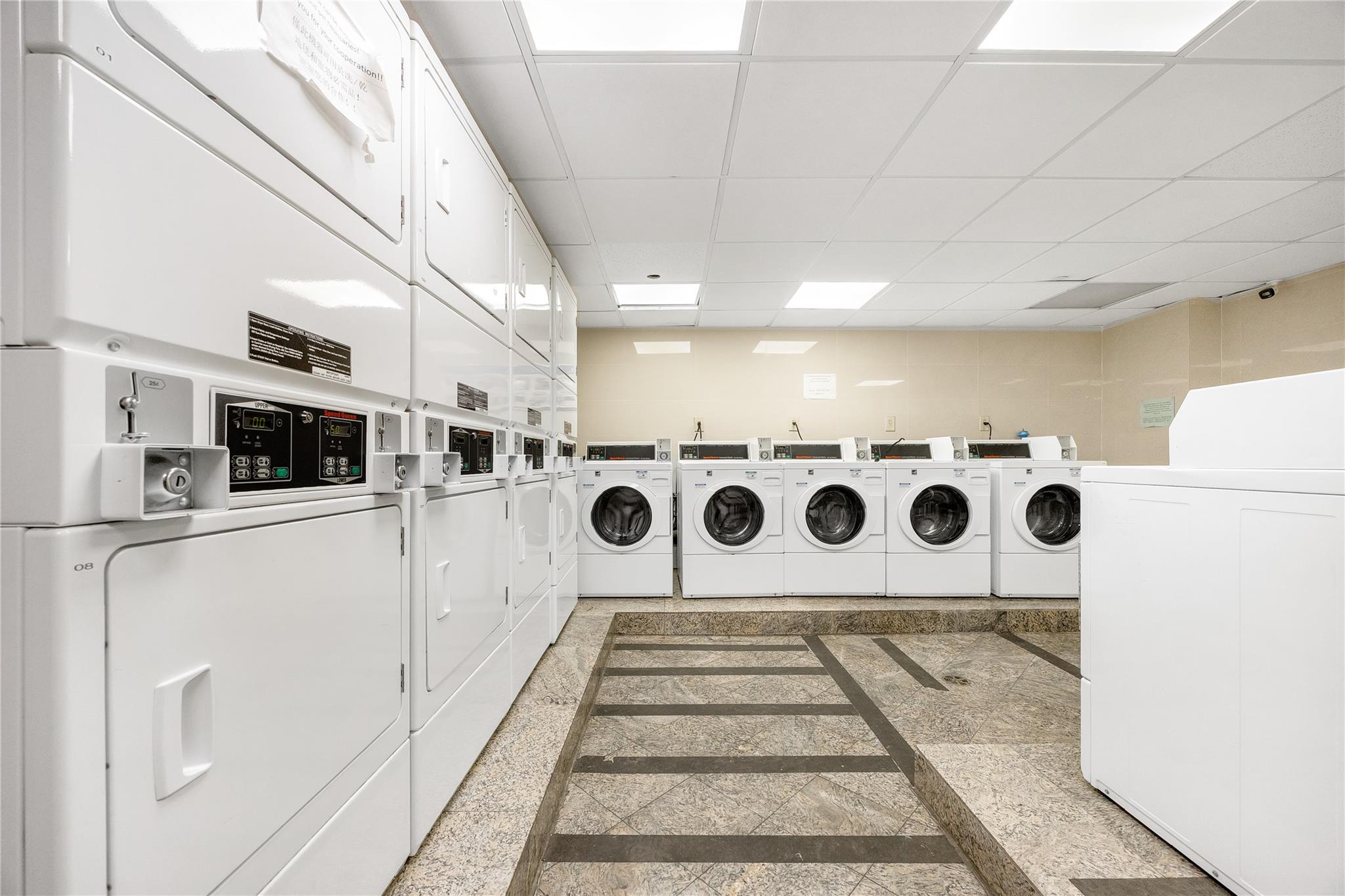 133-38 Sanford Avenue, Unit 20B Queens, NY 11355 - Photo 3 of 6 a utility room with dryer and washer