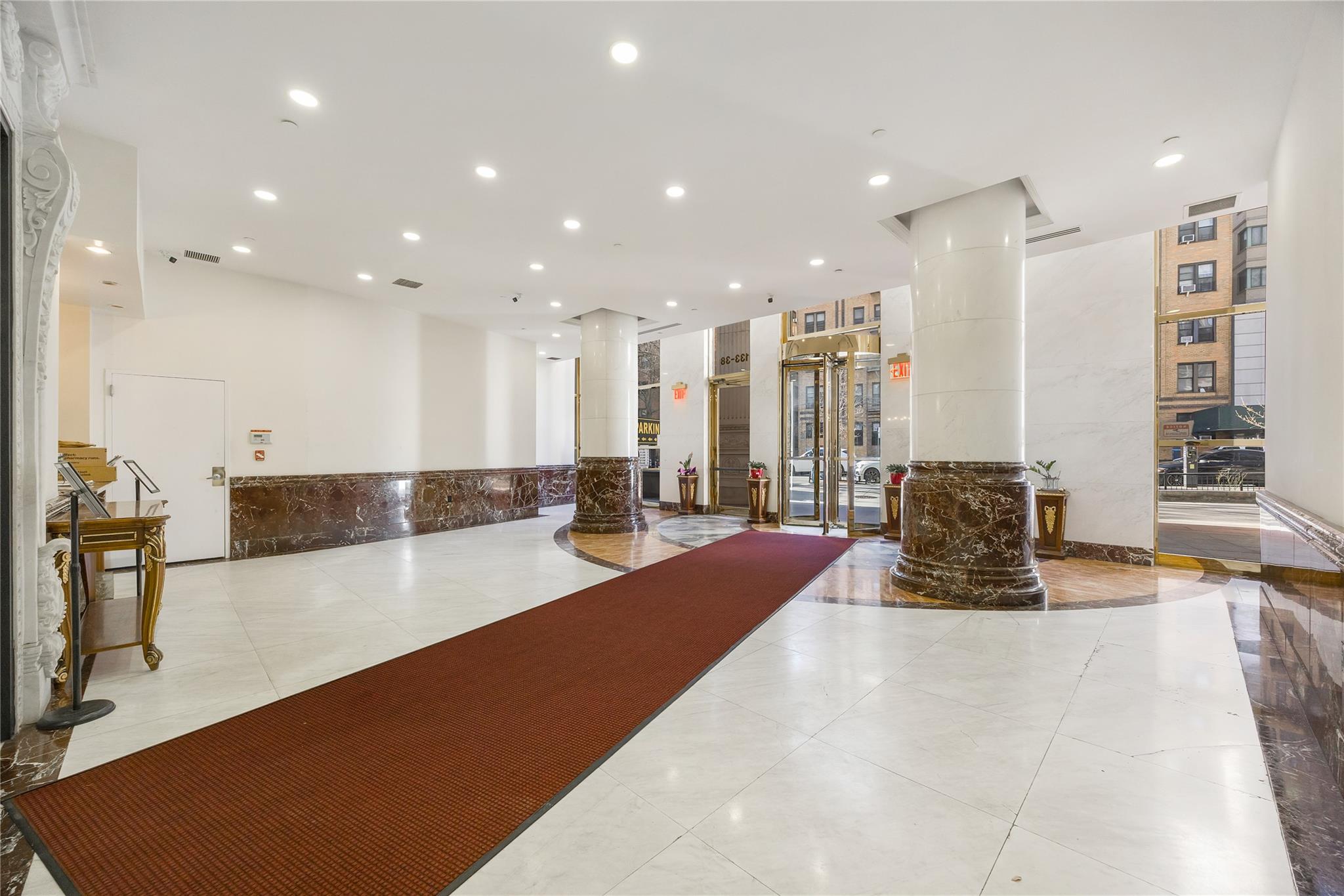 133-38 Sanford Avenue, Unit 20B Queens, NY 11355 - Photo 4 of 6 a large room with pool table and chairs