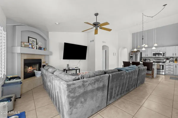 a living room with furniture a flat screen tv and a fireplace