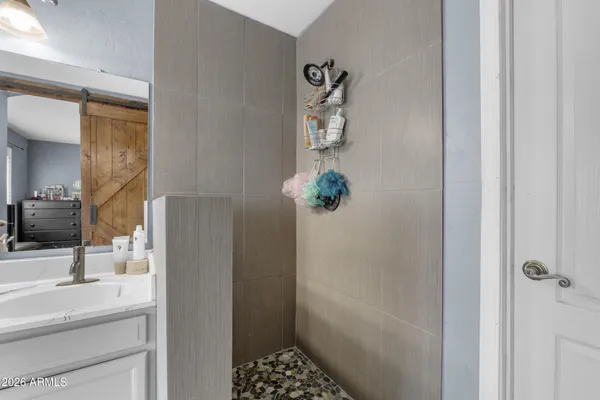 a spacious bathroom with sink shower and bathtub