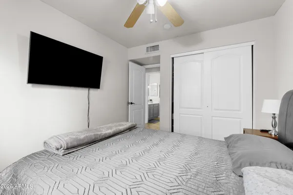 a bedroom with a bed and a chandelier