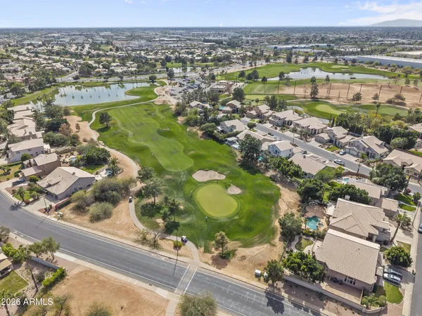 an aerial view of lake residential houses with outdoor space and swimming pool