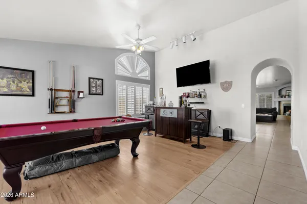 a living room with furniture a window and a flat screen tv