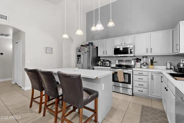 a kitchen with refrigerator and cabinets