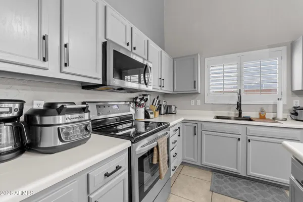 a kitchen with cabinets a sink and appliances