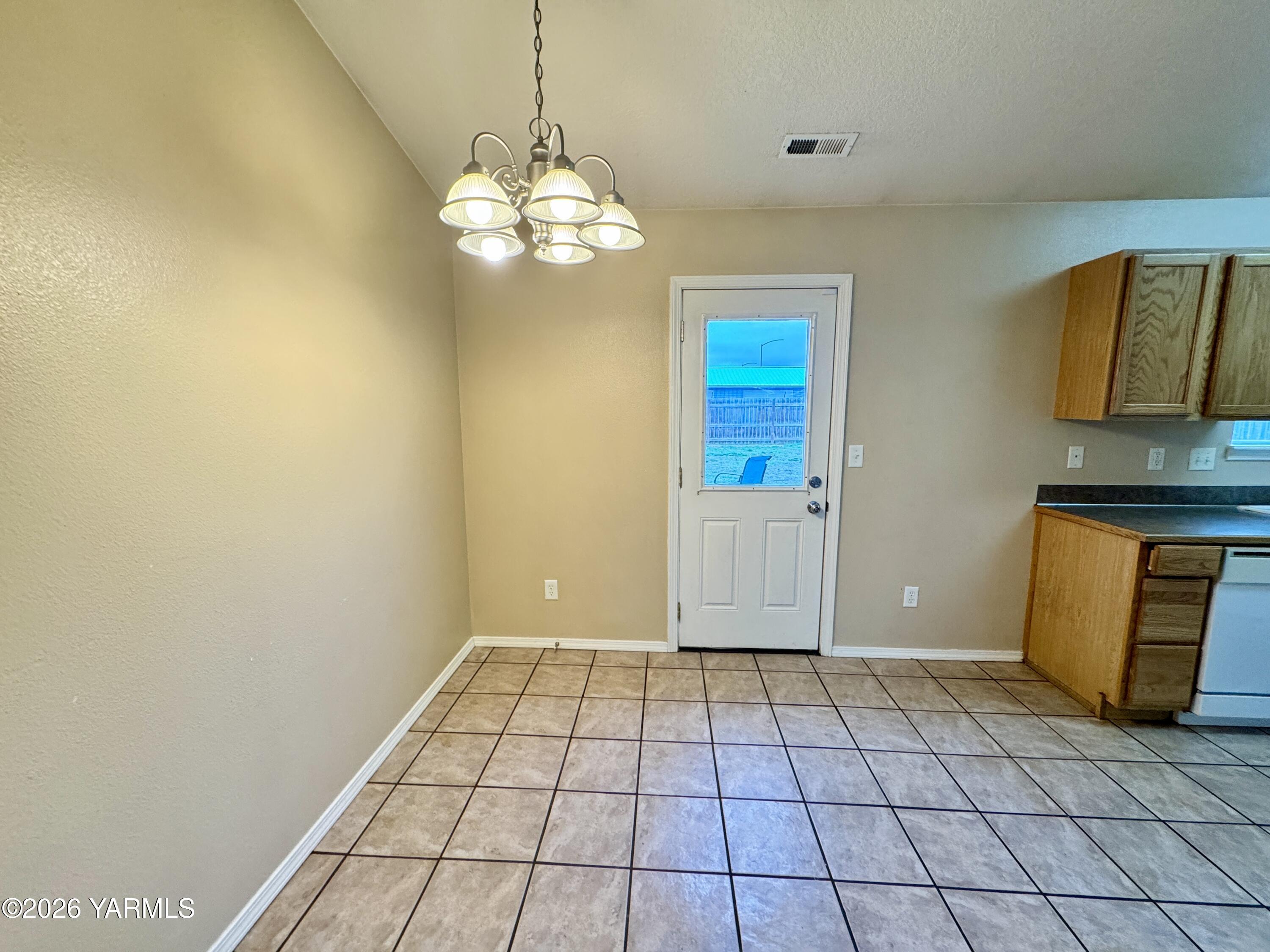 815 Jessica Court Grandview, WA 98930 - Photo 11 of 27 a view of an empty room with window and wooden floor