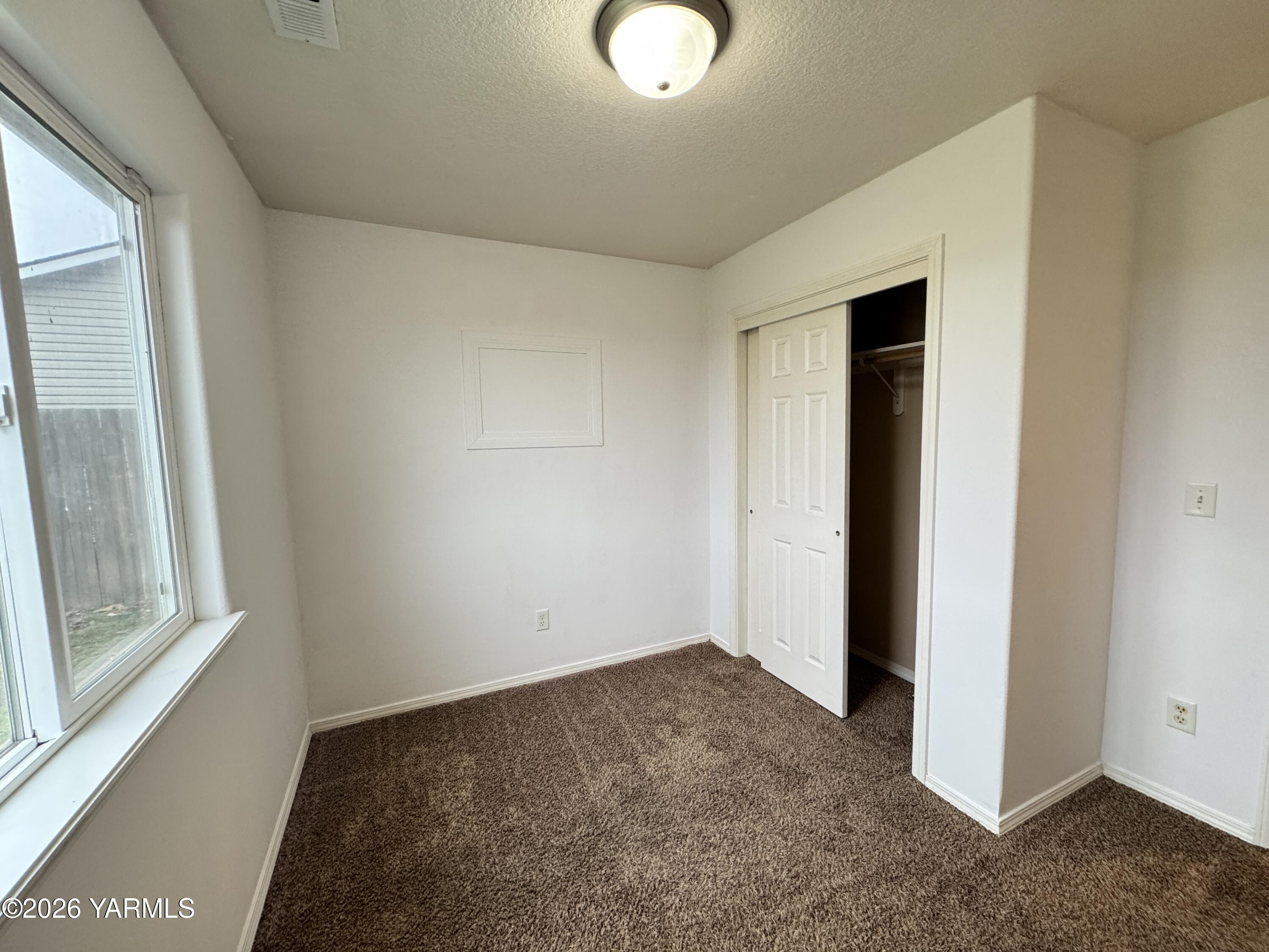 815 Jessica Court Grandview, WA 98930 - Photo 20 of 27 a view of a room with wooden floor and windows