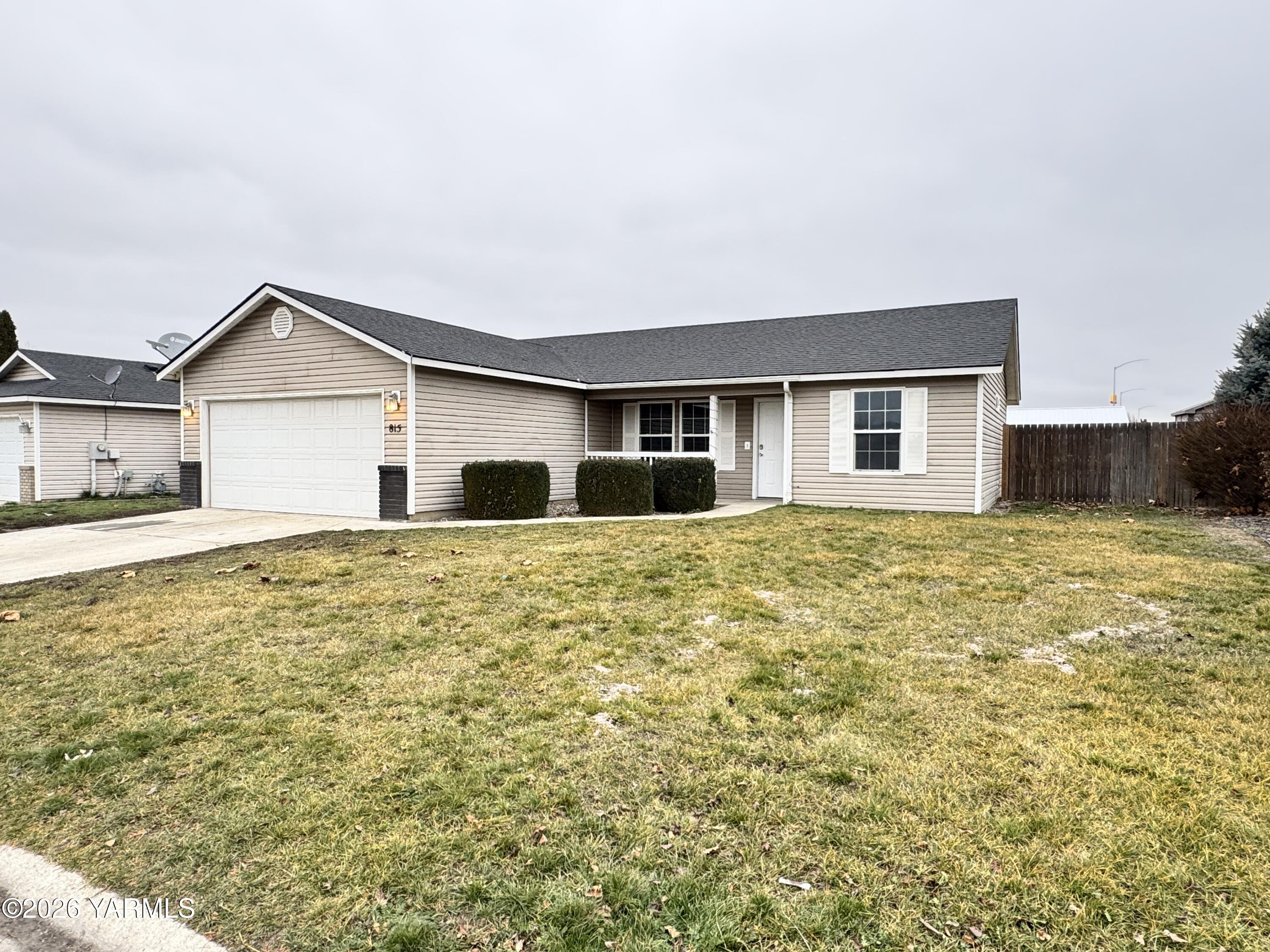 815 Jessica Court Grandview, WA 98930 - Photo 2 of 27 a front view of a house with a yard