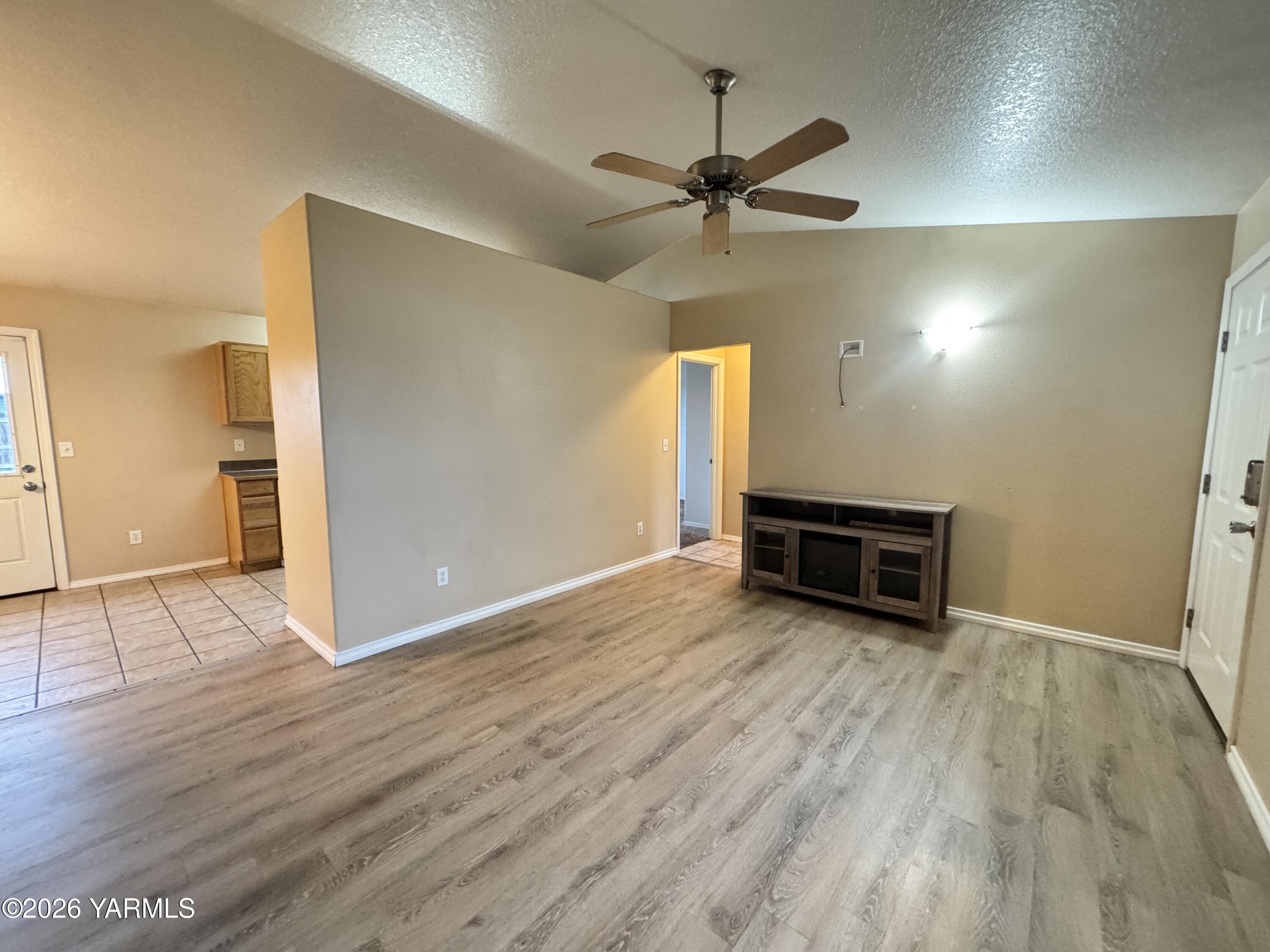 815 Jessica Court Grandview, WA 98930 - Photo 3 of 27 wooden floor in an empty room with a window
