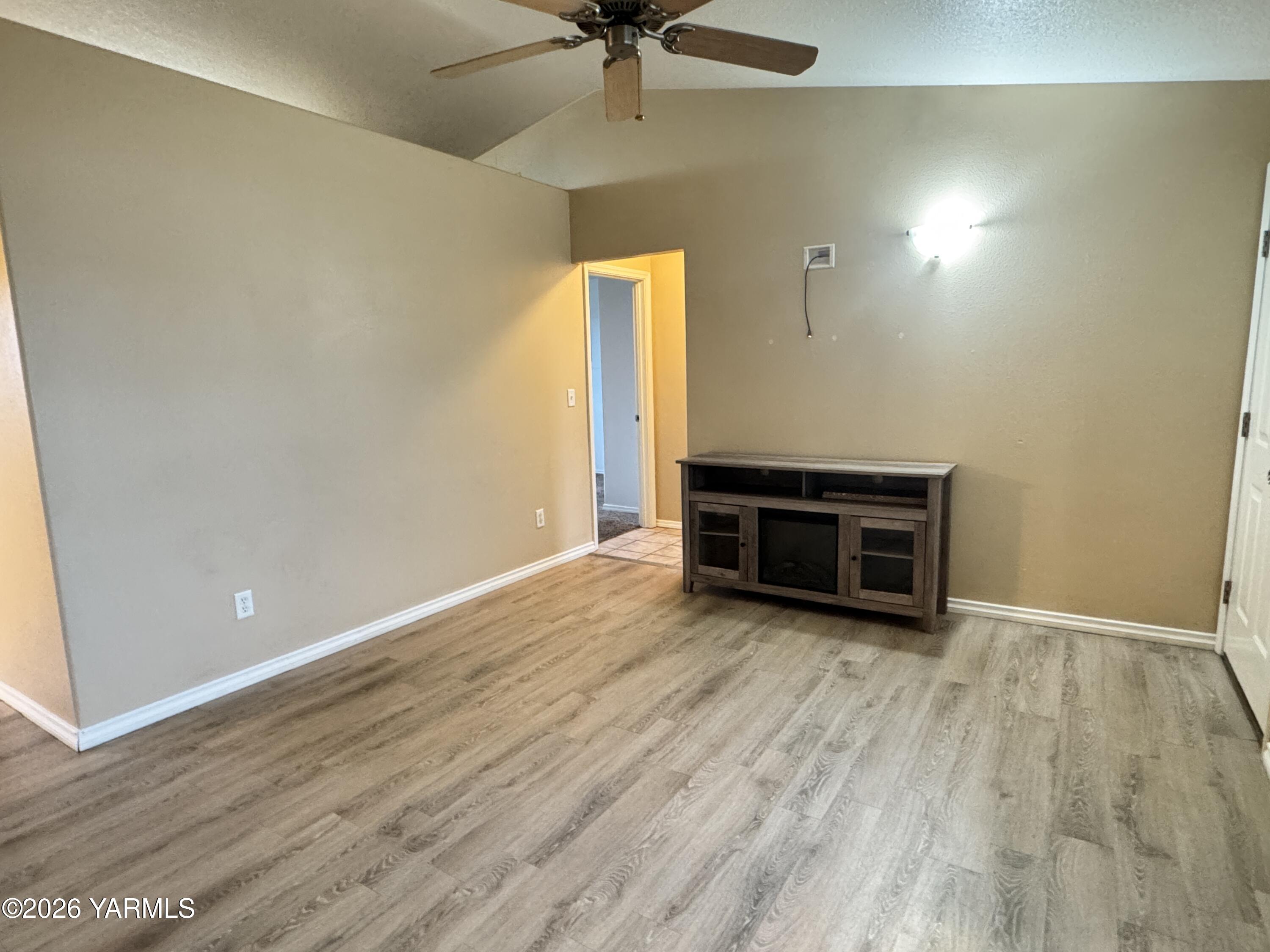 815 Jessica Court Grandview, WA 98930 - Photo 4 of 27 wooden floor in an empty room with a window