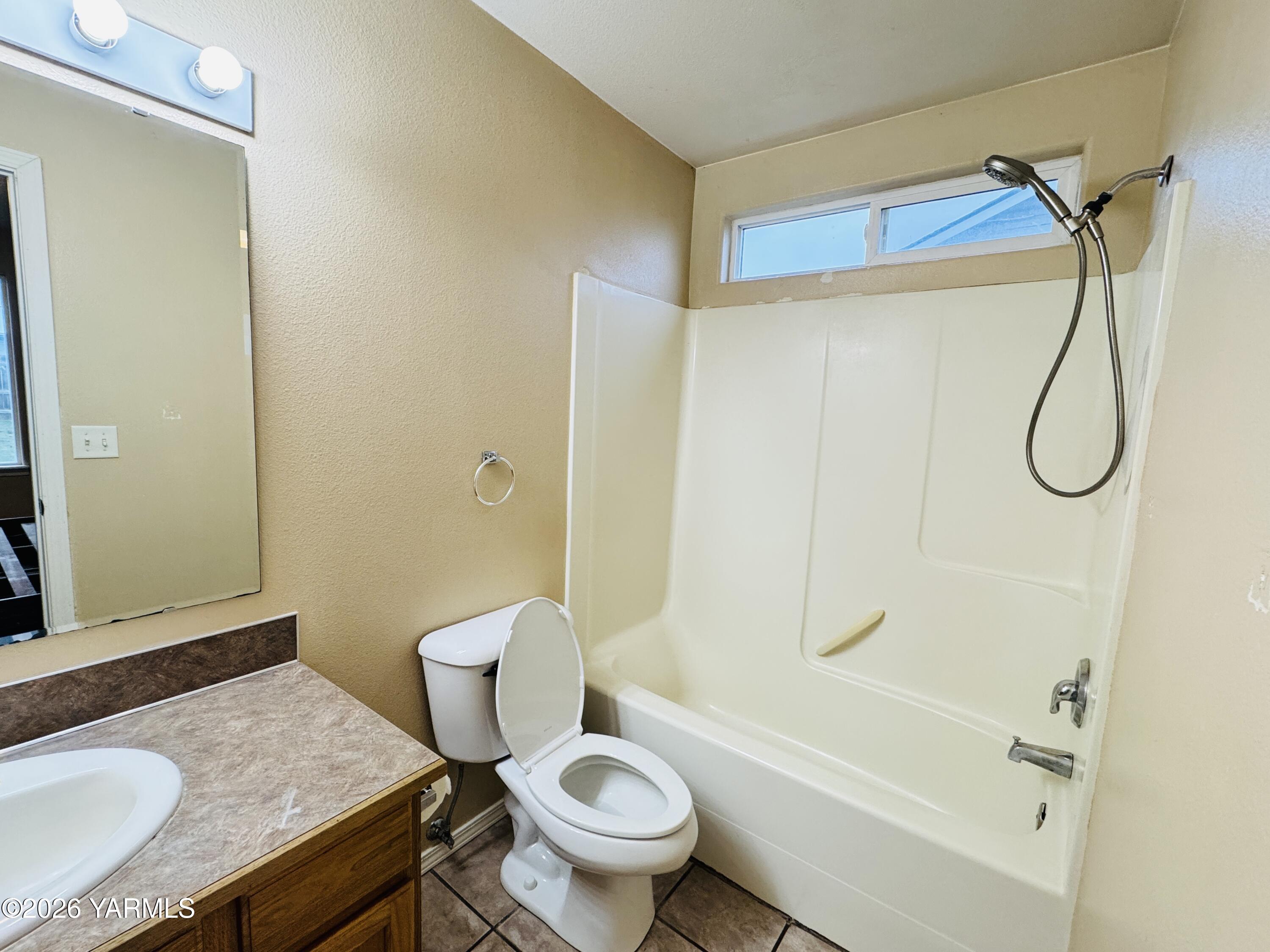 815 Jessica Court Grandview, WA 98930 - Photo 9 of 27 a bathroom with a granite countertop sink toilet and shower