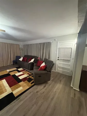 a spacious bedroom with a bed and a chandelier