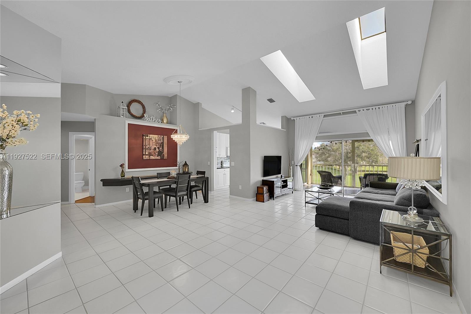 17317 Boca Club Boulevard, Unit 7 Boca Raton, FL 33487 - Photo 11 of 48 a living room with furniture and a large window