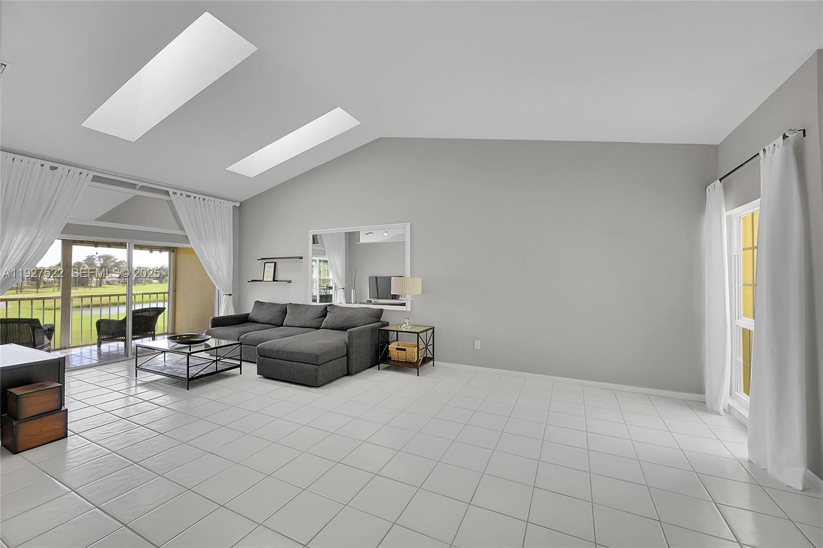 17317 Boca Club Boulevard, Unit 7 Boca Raton, FL 33487 - Photo 12 of 48 a living room with furniture and a large window