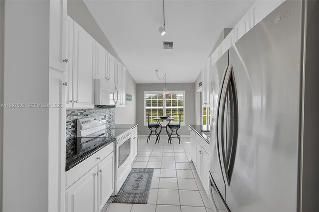 a kitchen with granite countertop a stove and a sink