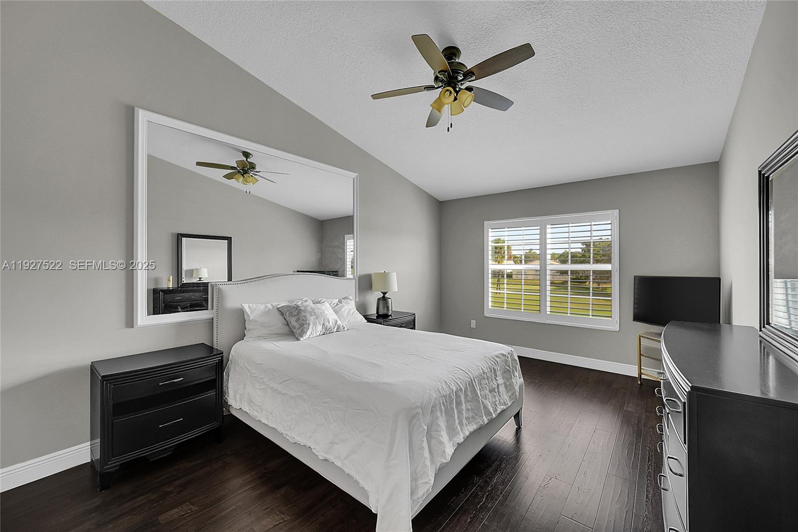 17317 Boca Club Boulevard, Unit 7 Boca Raton, FL 33487 - Photo 26 of 48 a bedroom with a bed a chandelier and a window