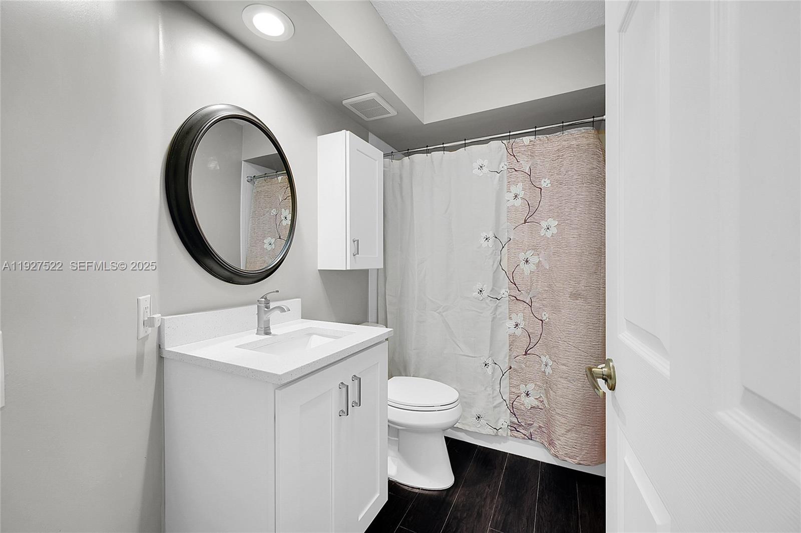 17317 Boca Club Boulevard, Unit 7 Boca Raton, FL 33487 - Photo 33 of 48 a bathroom with a toilet a sink and a mirror