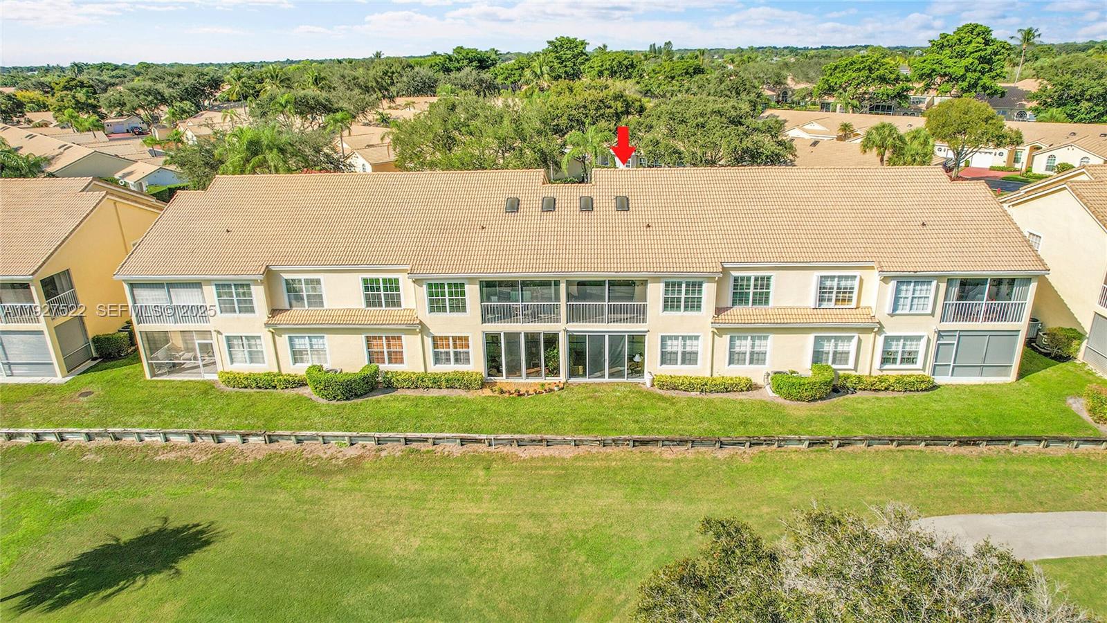 17317 Boca Club Boulevard, Unit 7 Boca Raton, FL 33487 - Photo 40 of 48 a front view of a house with a garden and swimming pool