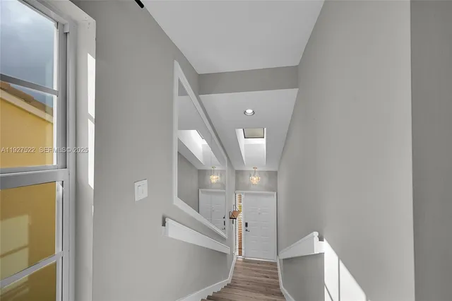 a view of entryway and hall with wooden floor